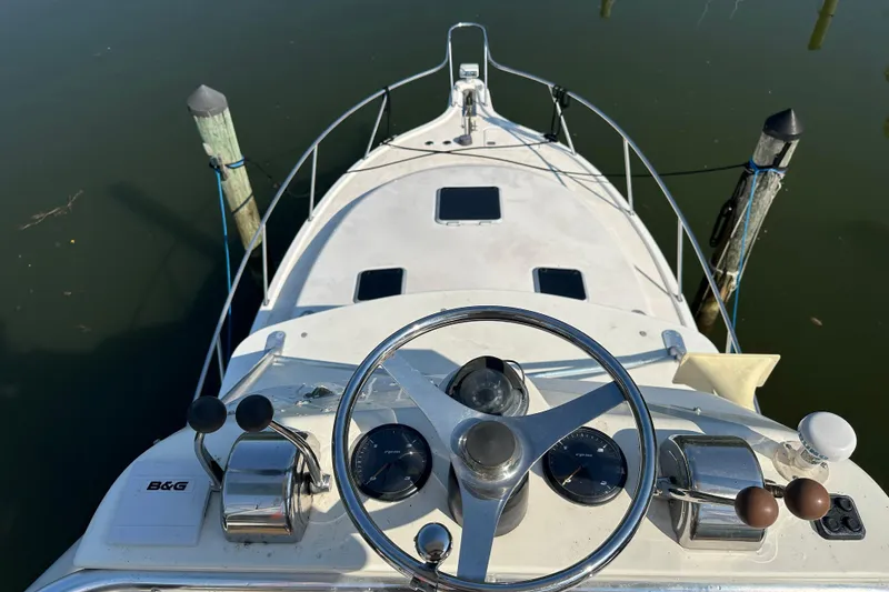 Slide: The Image of Helm view of 2000 Pursuit 3400 Express boat docked at marina. - 36