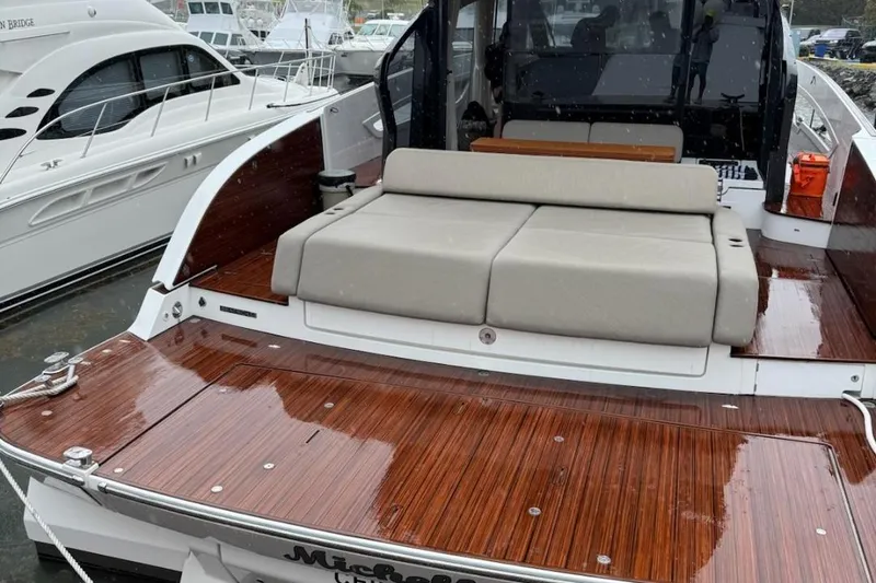 Slide: The Image of Azimut SeaDeck6 2025 yacht with sleek wooden deck and comfortable seating. - 6