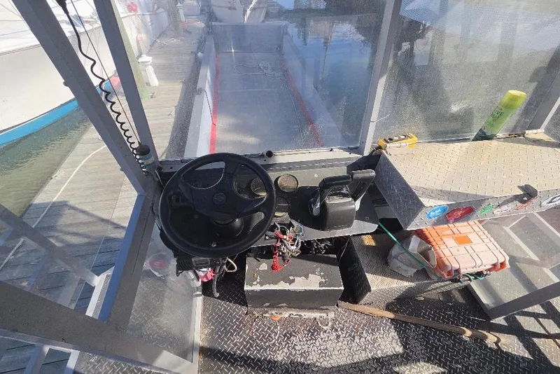 Slide: The Image of Cockpit of a 2012 Cool Amphibious Manufacturers International Landing Craft with steering wheel and controls. - 13