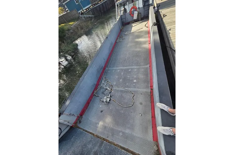Slide: The Image of Interior view of a 2012 Cool Amphibious Manufacturers International Landing Craft with ropes and dock. - 15