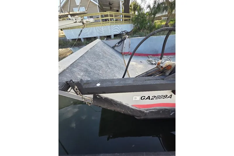 Slide: The Image of Amphibious landing craft by Cool Amphibious Manufacturers International, 2012 model, docked near a building. - 4