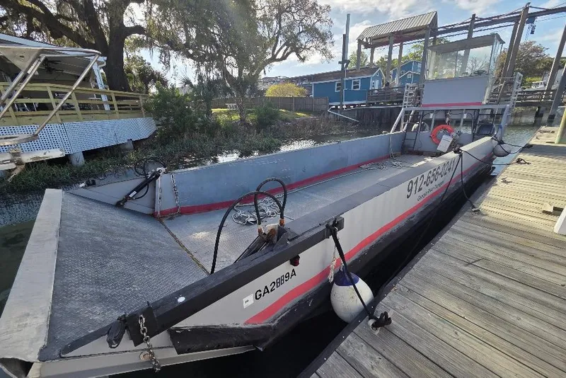 Slide: The Image of Amphibious landing craft by Cool Amphibious Manufacturers International, 2012, docked at a marina. - 5