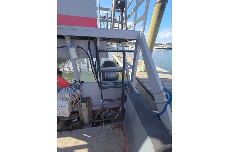 Slide: The Image of 2012 Cool Amphibious Manufacturers International Landing Craft docked, featuring ladder and nautical equipment. - 9