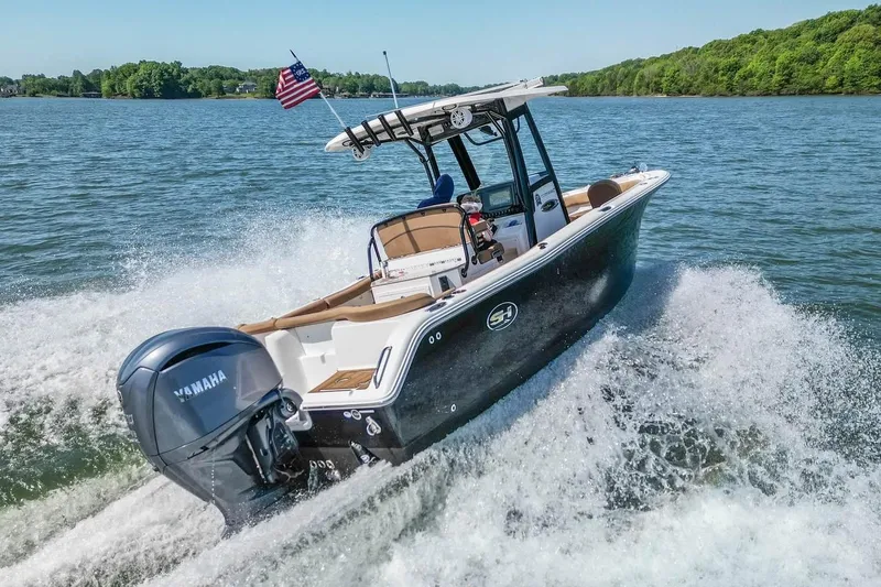 Slide: The Image of 2021 Sea Hunt Ultra 255 SE boat cruising on a lake with Yamaha engine. - 3