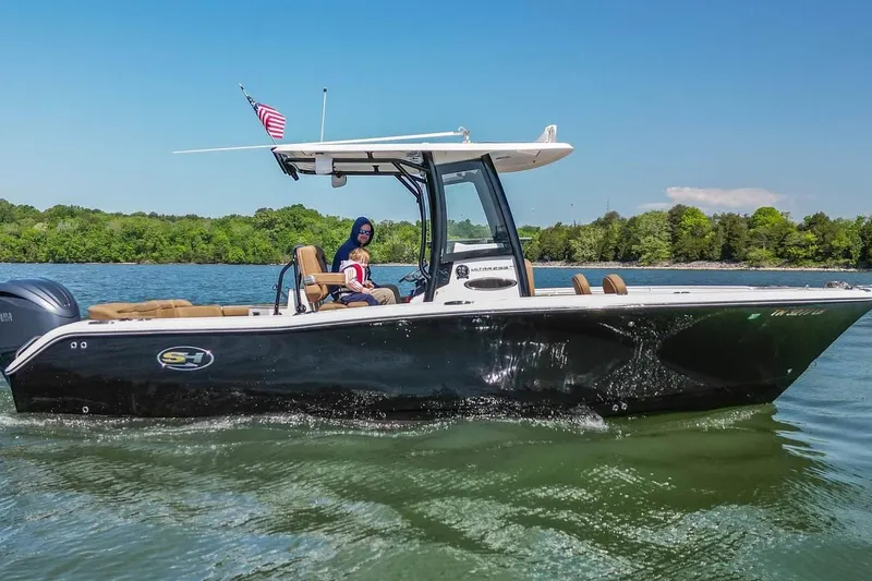 Slide: The Image of 2021 Sea Hunt Ultra 255 SE boat cruising on a lake with passengers. - 4