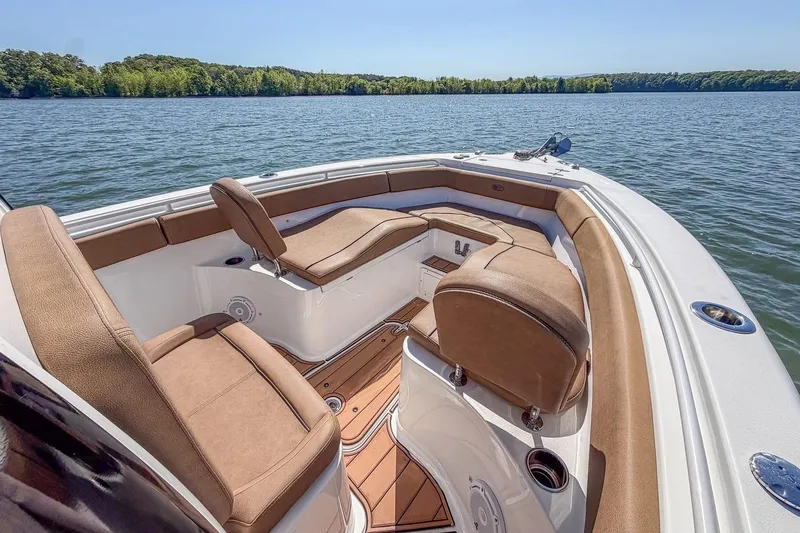 Slide: The Image of Luxurious 2021 Sea Hunt Ultra 255 SE boat interior with comfortable seating on a serene lake. - 7