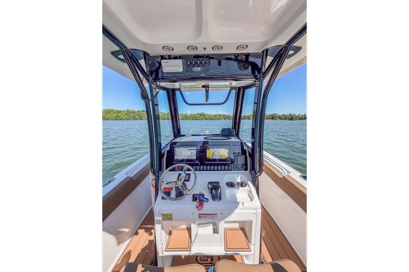 Slide: The Image of 2021 Sea Hunt Ultra 255 SE boat cockpit with steering wheel and navigation system. - 9