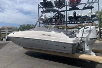 The Image of 2021 Hurricane Center Console 19 OB boat with Suzuki outboard motor on a dock. - 1