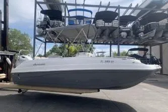 Slide: The Image of 2021 Hurricane Center Console 19 OB boat in storage, side view. - 3