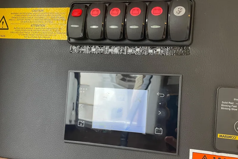 Slide: The Image of Control panel of a 2017 Jeanneau Leader 46 boat with switches and display screen. - 24
