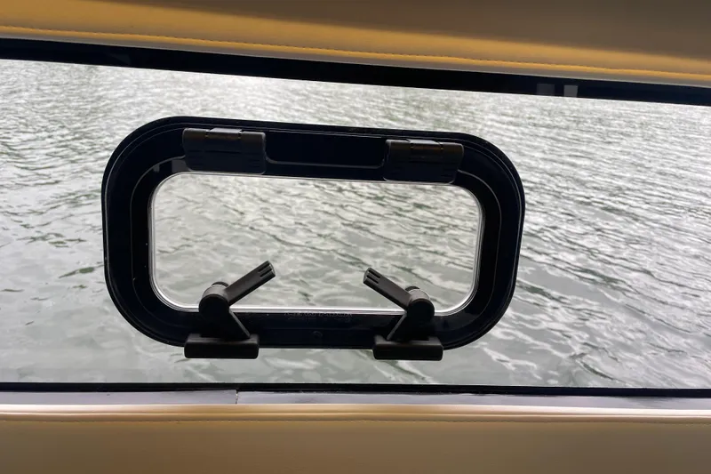 Slide: The Image of Open window view from 2017 Jeanneau Leader 46 yacht, overlooking calm water. - 47