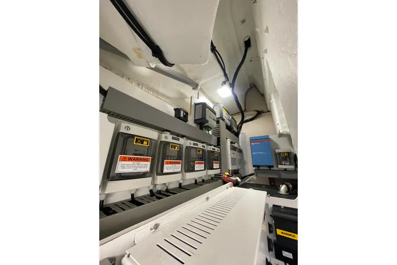Slide: The Image of Electrical system inside a 2017 Jeanneau Leader 46 boat, featuring warning labels and wiring. - 62