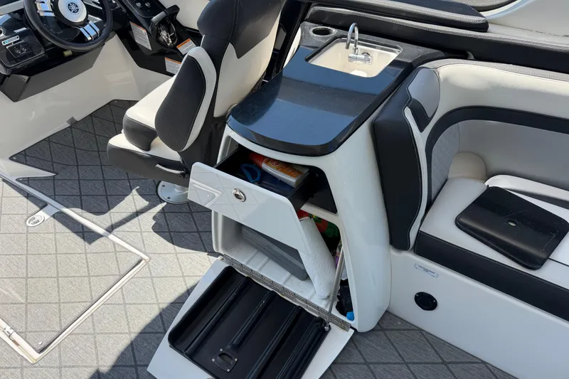 Slide: The Image of 2020 Yamaha Boats 275SD interior with helm, seating, and storage compartments. - 10