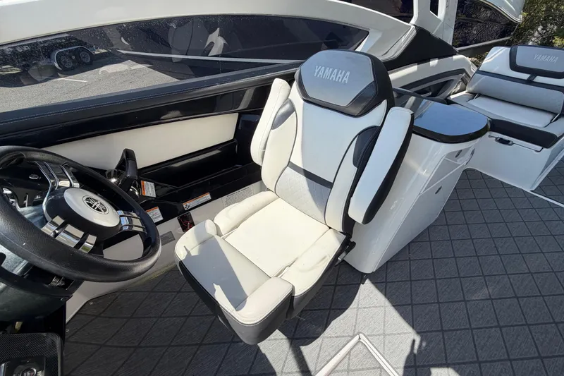 Slide: The Image of 2020 Yamaha Boats 275SD interior with steering wheel and seating, showcasing luxury design. - 13