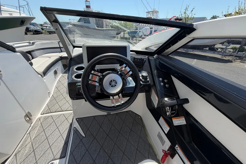 Slide: The Image of 2020 Yamaha Boats 275SD cockpit with steering wheel and control panel. - 14