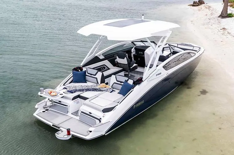 Slide: The Image of Manufacturer Provided Image: 2020 Yamaha Boats 275SD anchored on a sandy beach, showcasing luxury and style. - 4