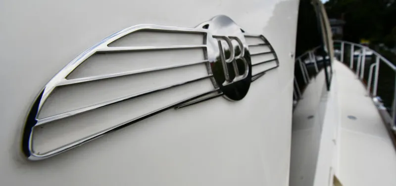 Slide: The Image of 2020 Palm Beach Motor Yachts PB52 emblem on sleek white yacht exterior. - 13