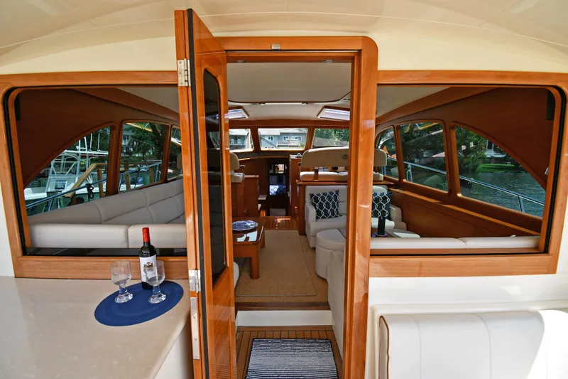 Slide: The Image of Luxurious interior of 2020 Palm Beach Motor Yachts PB52, featuring elegant wood finishes and plush seating. - 17