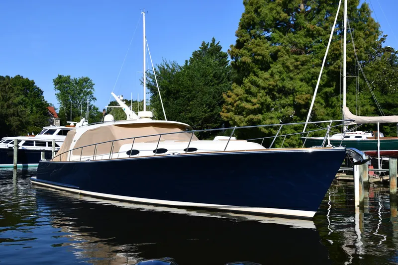 Slide: The Image of 2020 Palm Beach Motor Yachts PB52 docked, sleek design, surrounded by trees and water. - 5