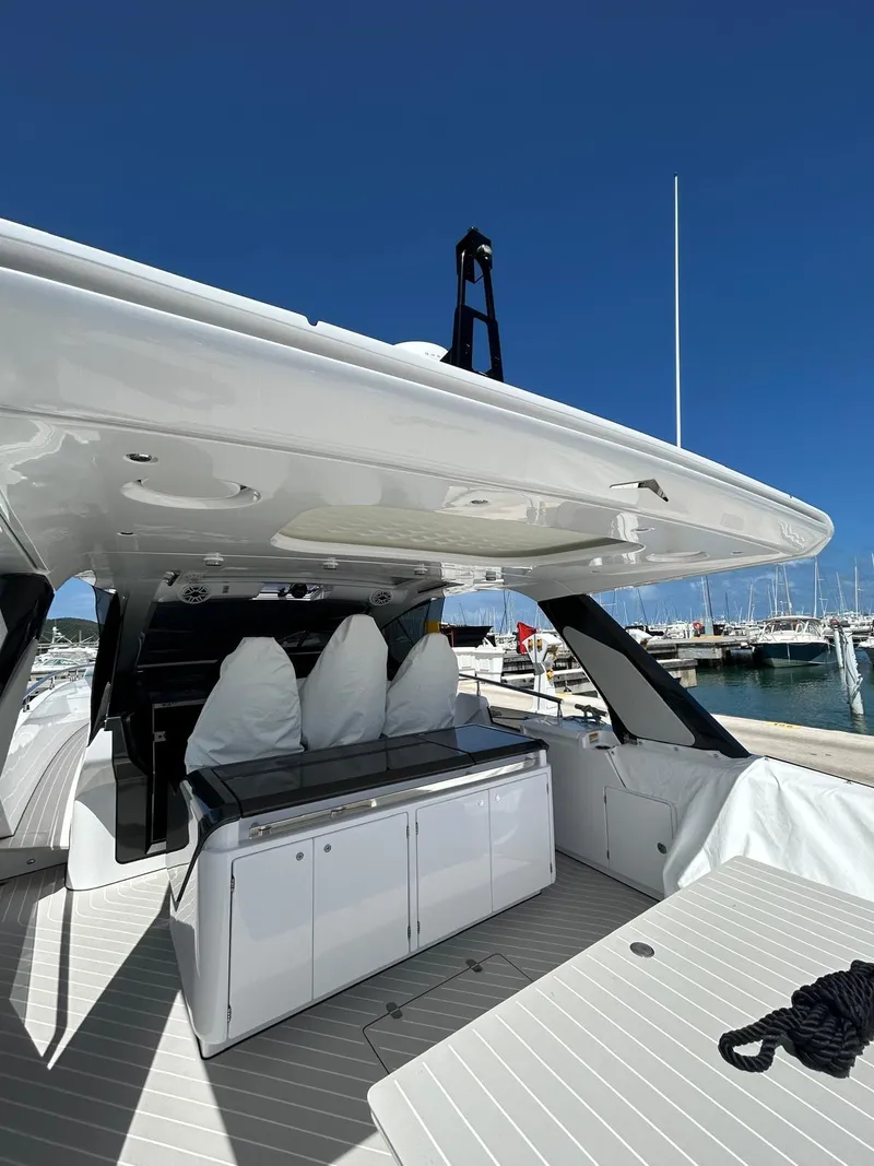 Slide: The Image of 2024 Azimut Verve 48 yacht, sleek design, docked at marina under clear blue sky. - 11