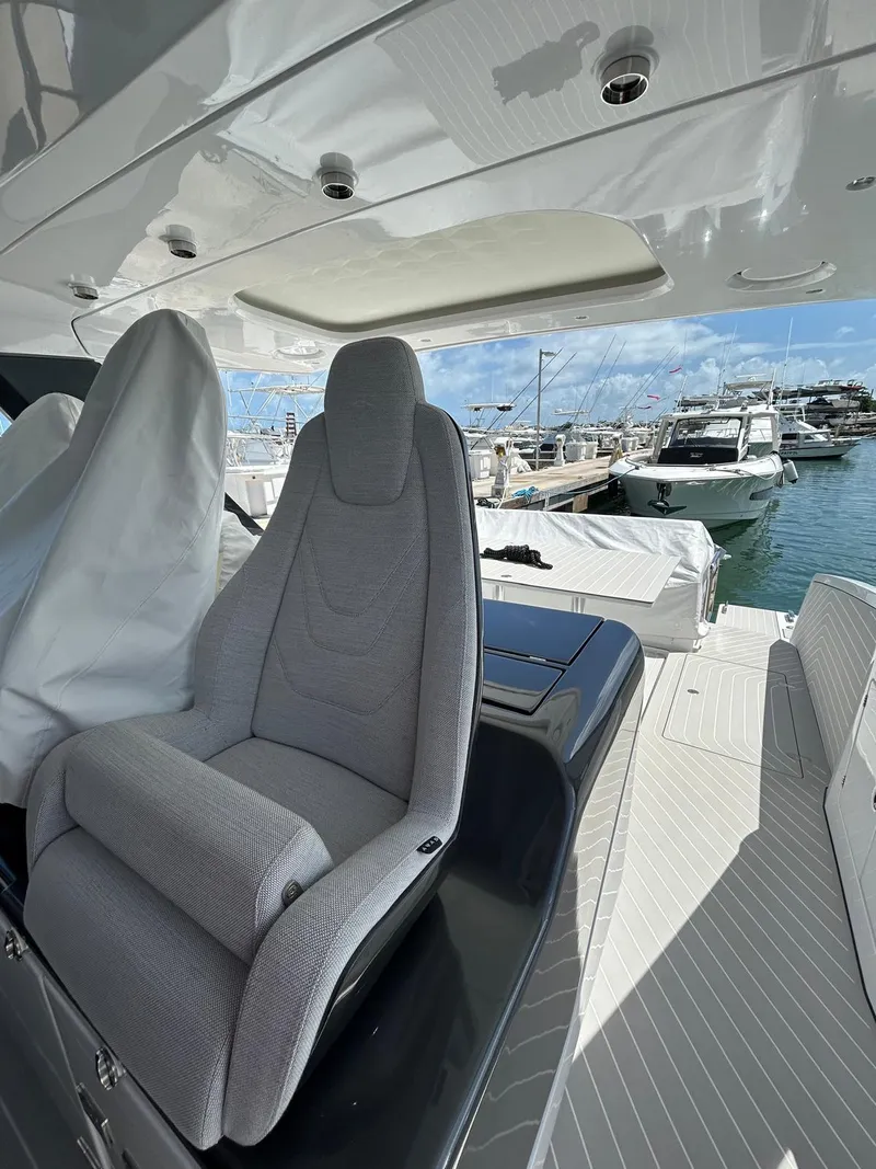 Slide: The Image of 2024 Azimut Verve 48 yacht interior with plush seating and marina view. - 14