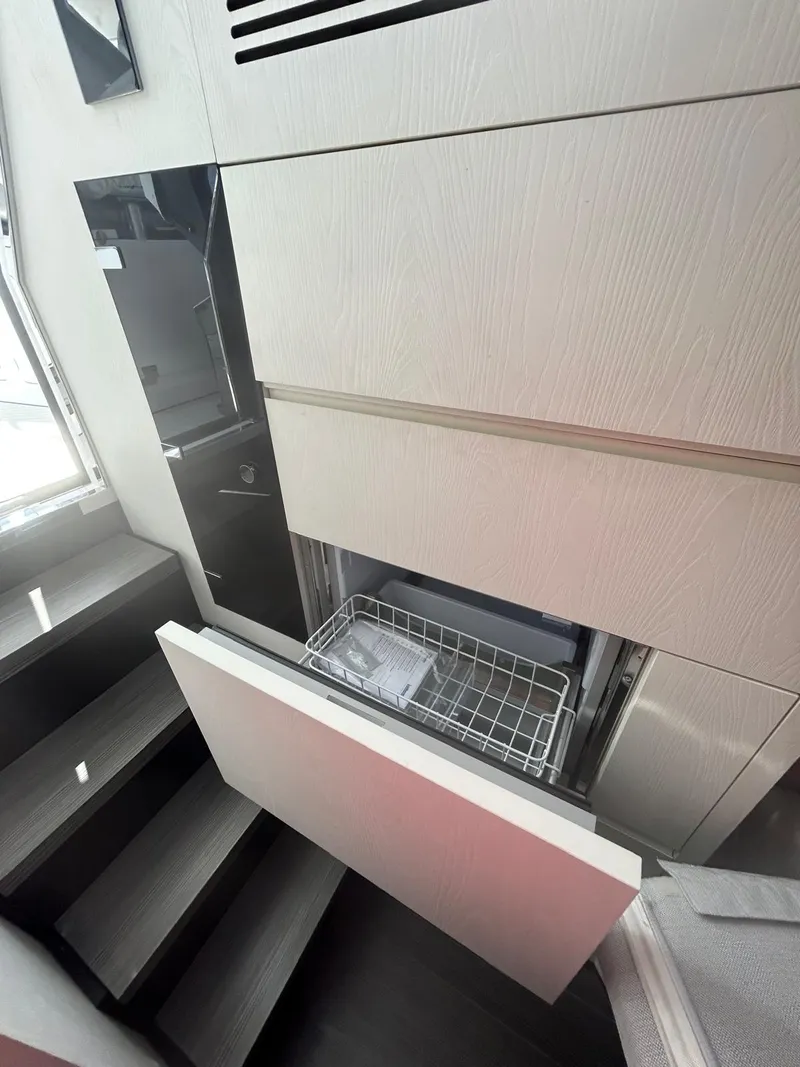 Slide: The Image of 2024 Azimut Verve 48 yacht interior with built-in dishwasher and modern cabinetry. - 18