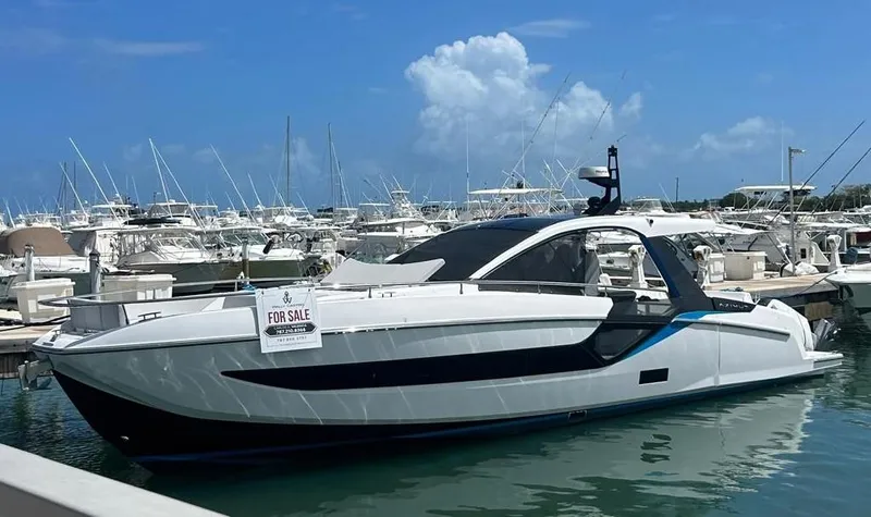 Slide: The Image of 2024 Azimut Verve 48 yacht for sale, docked in a marina under a clear blue sky. - 2