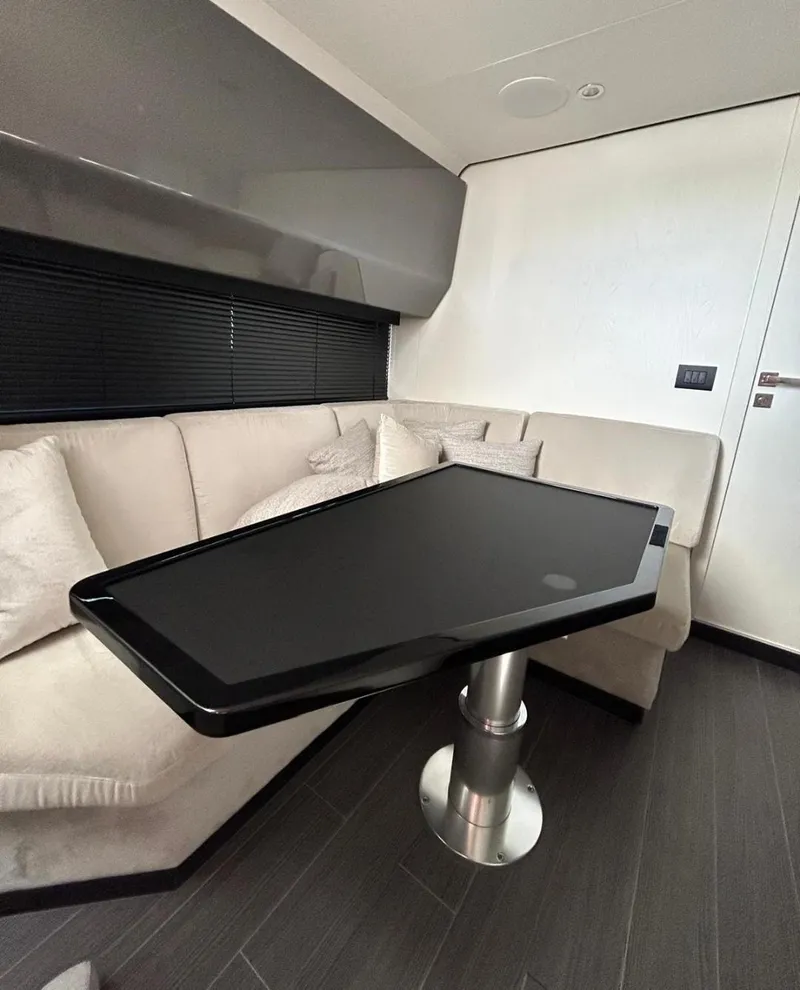 Slide: The Image of 2024 Azimut Verve 48 interior with sleek black table and beige seating. - 20