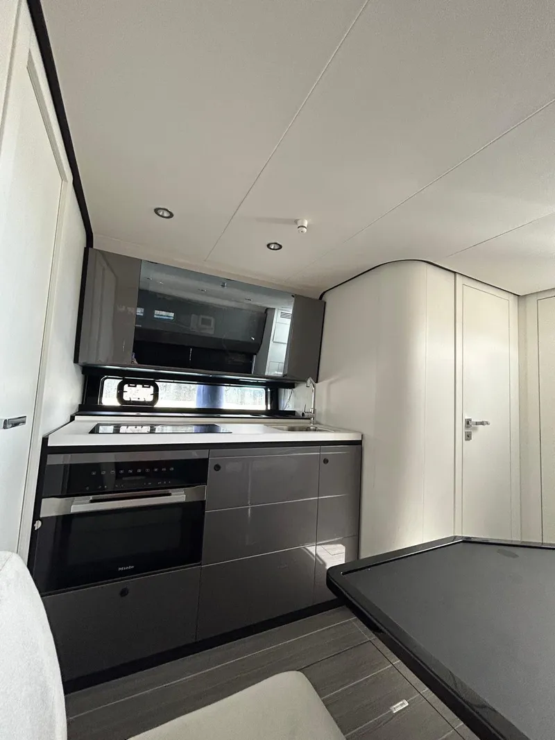 Slide: The Image of 2024 Azimut Verve 48 yacht interior kitchen with modern appliances and sleek design. - 21