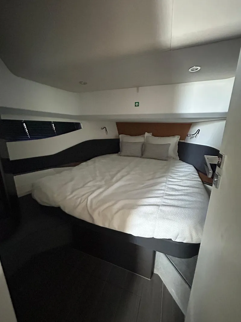 Slide: The Image of 2024 Azimut Verve 48 cabin with a cozy bed and modern design. - 22