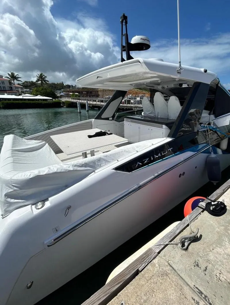 Slide: The Image of 2024 Azimut Verve 48 luxury yacht docked at marina under blue sky. - 3