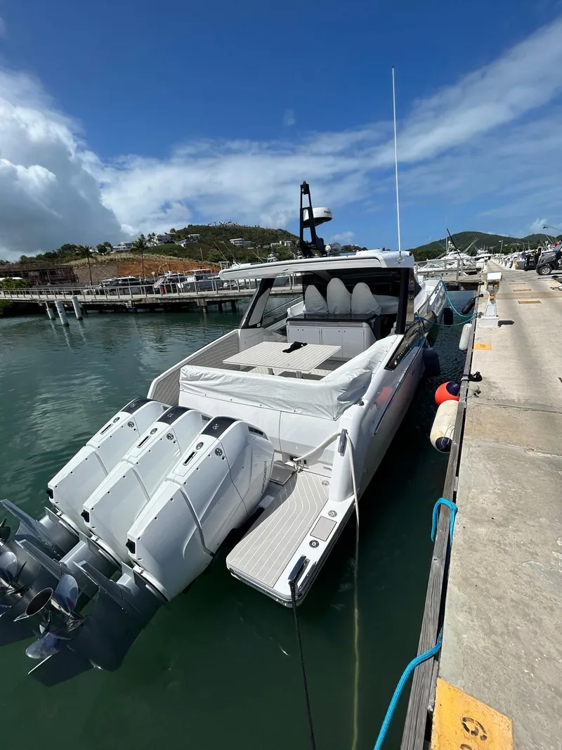 Slide: The Image of 2024 Azimut Verve 48 luxury yacht docked at marina, featuring powerful outboard engines. - 6