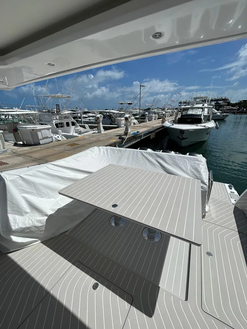 Slide: The Image of 2024 Azimut Verve 48 yacht docked at marina with table setup. - 8