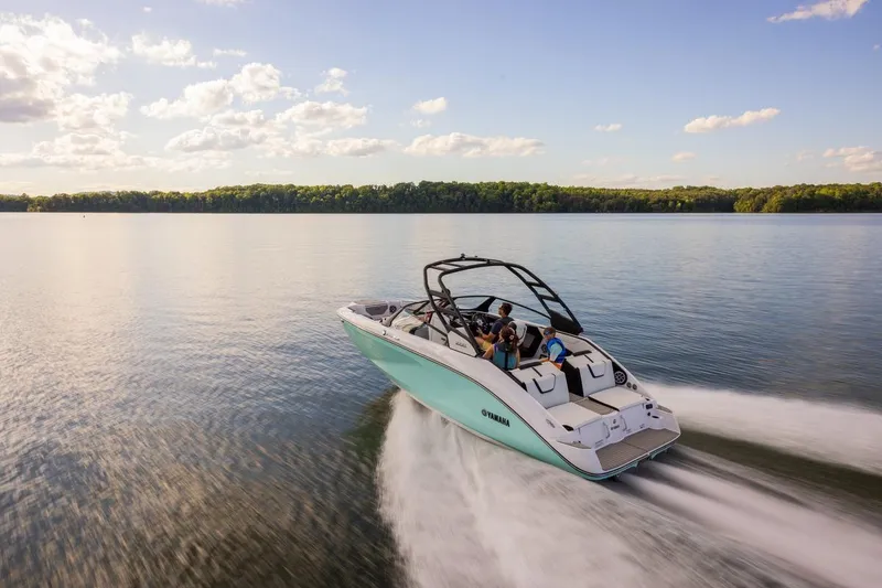 Slide: The Image of 2026 Yamaha Boats 222S cruising on a serene lake under a partly cloudy sky. - 10