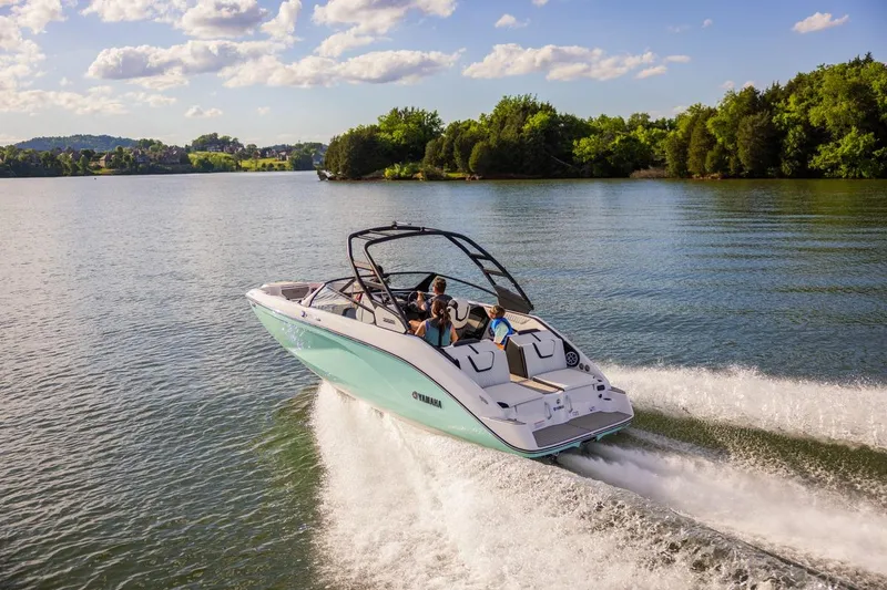 Slide: The Image of 2026 Yamaha Boats 222S cruising on a scenic lake under a clear blue sky. - 12