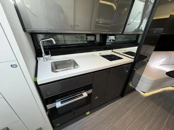 Slide: The Image of 2024 Azimut Verve 42 yacht interior kitchen with modern appliances and sleek design. - 10