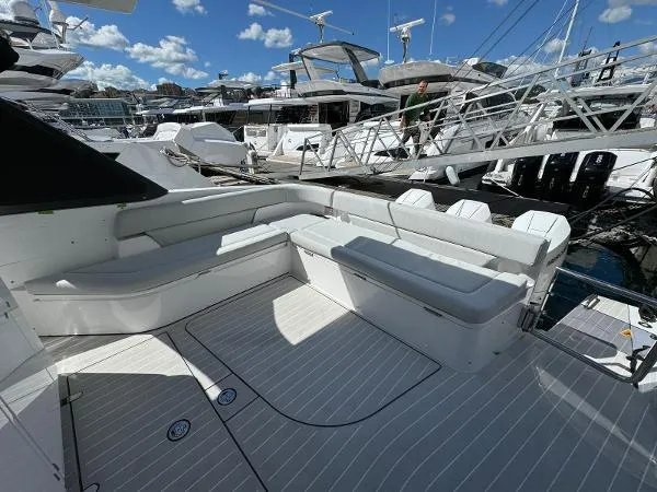 Slide: The Image of 2024 Azimut Verve 42 yacht with spacious deck seating at a marina. - 6