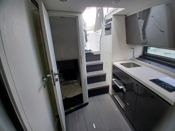 Slide: The Image of 2024 Azimut Verve 42 interior with modern kitchen and stairs to deck. - 9