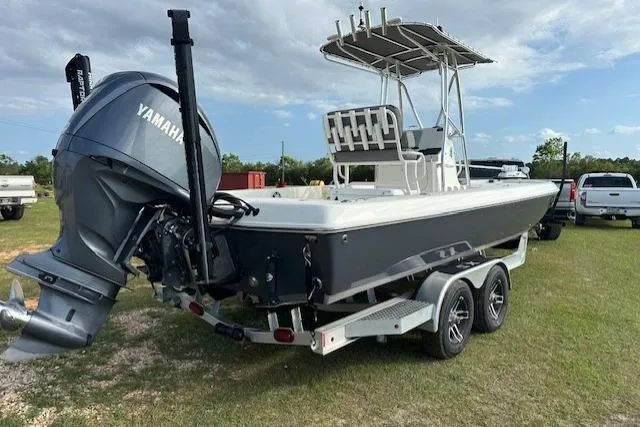 Slide: The Image of 2023 Skeeter SX240 boat with Yamaha engine on a trailer, parked on grass. - 3