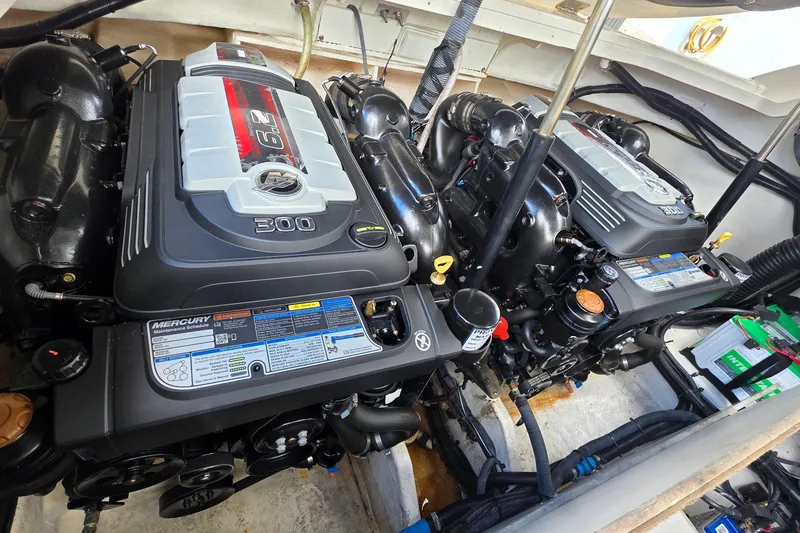 Slide: The Image of Twin Mercury engines in a 2015 Sea Ray SLX 350 boat engine compartment. - 12