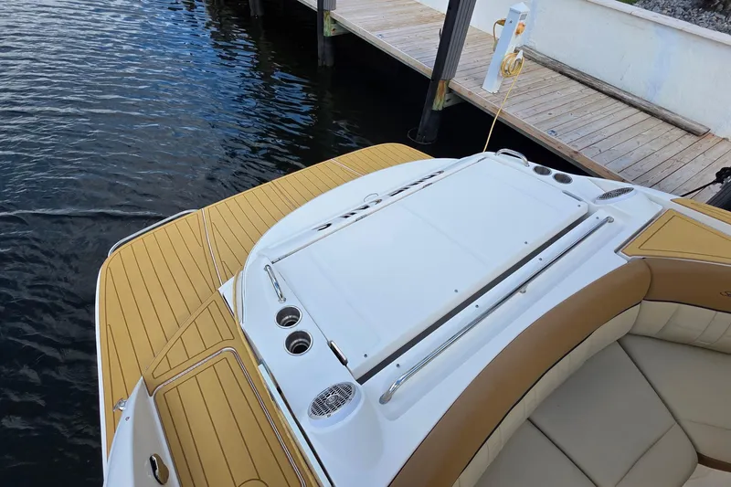 Slide: The Image of 2015 Sea Ray SLX 350 boat with tan deck, docked by wooden pier. - 19
