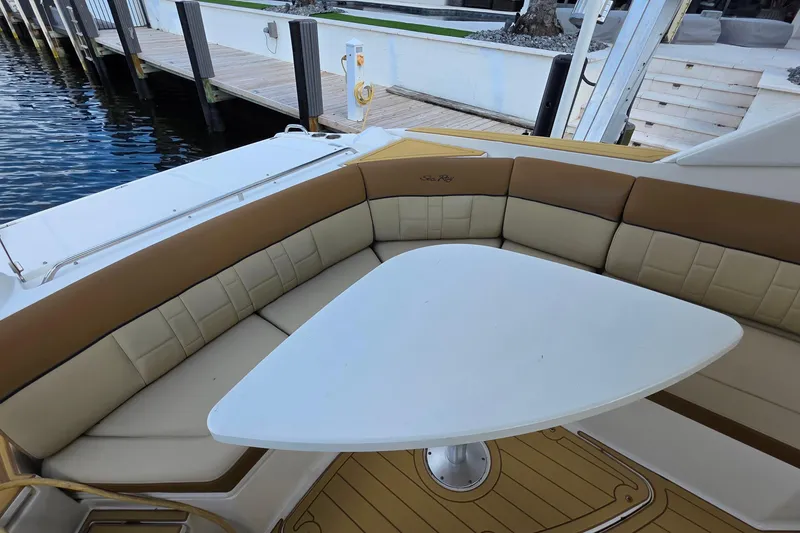 Slide: The Image of Luxurious seating area on a 2015 Sea Ray SLX 350 boat with a triangular table. - 22