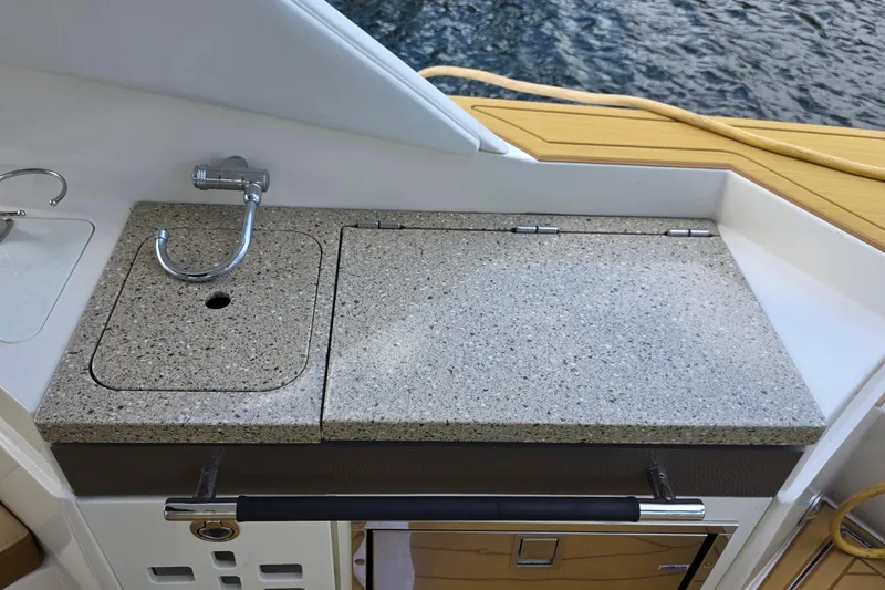 Slide: The Image of Outdoor kitchenette on 2015 Sea Ray SLX 350 boat with sink and countertop. - 23