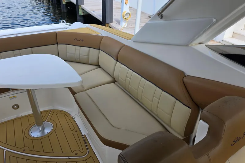 Slide: The Image of Luxurious seating area on a 2015 Sea Ray SLX 350 boat with a table. - 24