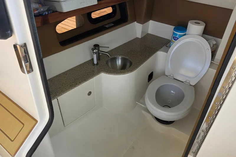 Slide: The Image of 2015 Sea Ray SLX 350 boat bathroom with sink, toilet, and storage. - 29