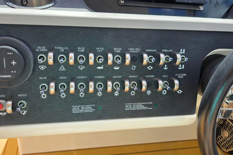 Slide: The Image of Control panel of a 2015 Sea Ray SLX 350 boat with labeled switches. - 33