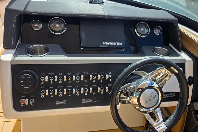 Slide: The Image of Control panel of a 2015 Sea Ray SLX 350 boat with steering wheel and gauges. - 34