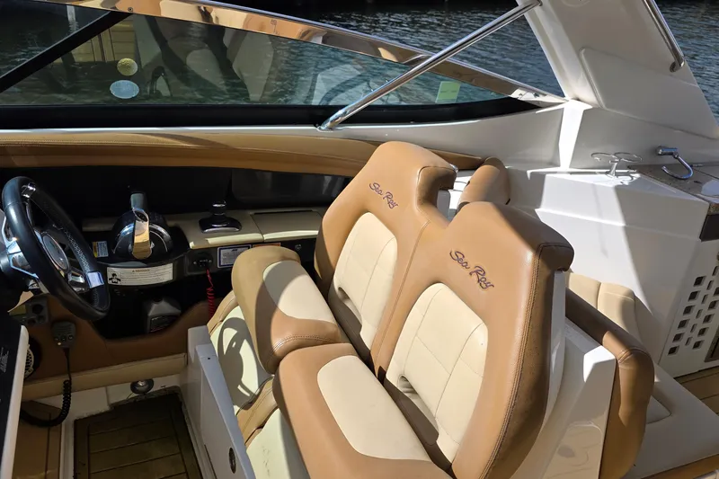 Slide: The Image of Interior of a 2015 Sea Ray SLX 350 boat with tan leather seats and steering wheel. - 35