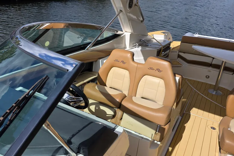 Slide: The Image of 2015 Sea Ray SLX 350 boat interior with tan leather seats and wooden deck. - 36