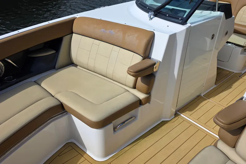 Slide: The Image of Luxurious seating on 2015 Sea Ray SLX 350 boat with tan upholstery and armrests. - 39